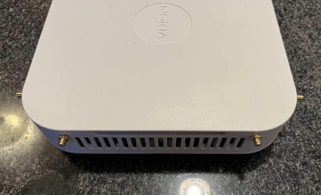 Finished project with four SMA connectors installed through two corners of the base station's top cover.